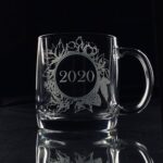 A personalized Christmas mug with a custom engraved message, filled with hot cocoa and marshmallows.