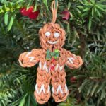 Spruce the Gingerbread Boy Christmas ornament with rhinestone buttons, made from brown rubber bands.