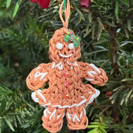 Holly the Gingerbread Girl Christmas ornament with rhinestone decorations, made from brown rubber bands.